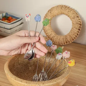Cute cartoon stainless steel stirring spoons and forks with fuzzy plush monster decor.