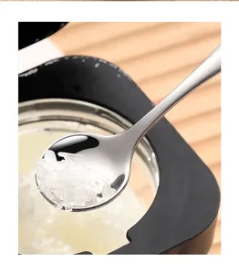 Stainless steel mini seasoning spoon detail shot, compact tableware for yogurt or dessert.