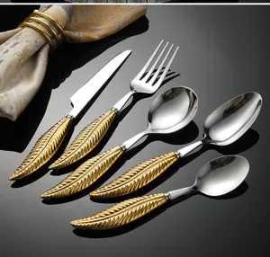 Stainless steel flatware set featuring elegant gold feather handles, 5-piece detail.