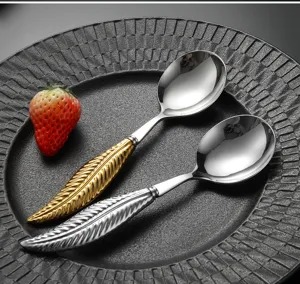 Stainless steel spoons featuring an elegant leaf handle design, ideal for modern dining tables.