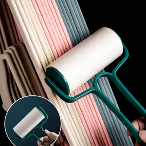 Lint roller for pet hair and clothes dust removal with ergonomic green handle and refills.