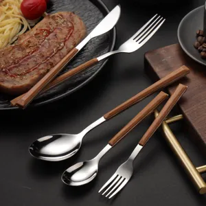 Stainless steel cutlery set with wood-grain handles including steak knife fork and spoon.