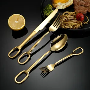 Gold stainless steel cutlery set with unique hanging hole handle for dining table decor.