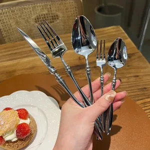 Detailed close-up of French vintage stainless steel cutlery set handle with elegant design.