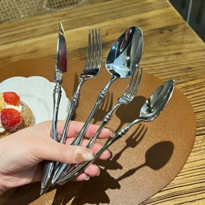 French 304 stainless steel flatware set, vintage embossed handle detail for elegant table setting.