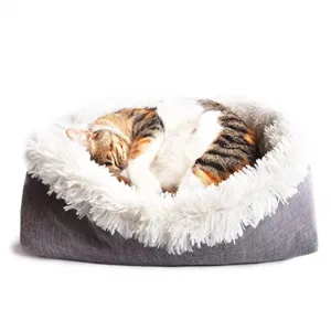 Close-up detail of plush pet bed interior showing soft white long faux fur texture for cozy pets.