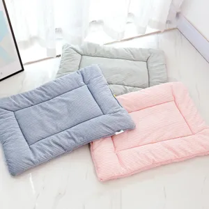 Striped pet mat detail showing soft cloud velvet fabric, raised edge and M size tag.