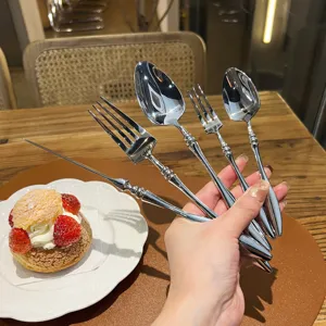 Detailed view of French stainless steel cutlery set with elegant beaded handle design.