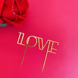 Gold acrylic LOVE cake topper for Valentine's Day party dessert decoration and celebration.