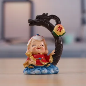 Close-up detail of Chinese longevity god figurine with dragon staff and peach for car decor.