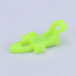 Detailed view of the fluorescent green plastic fishing hook keeper for outdoor rods.