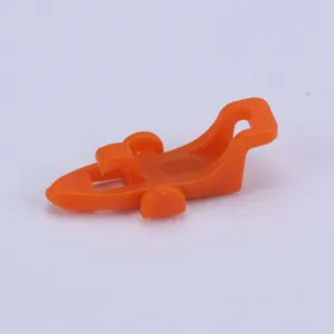 Orange plastic fishing rod hook keeper lure holder accessory for fishing gear detail shot.