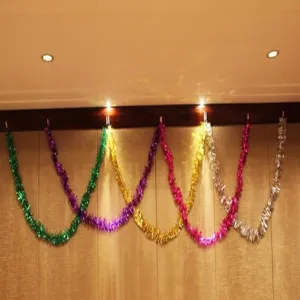 Close-up detail of colorful 2m tinsel garland hanging on wall for party celebration.