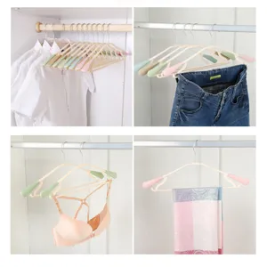 Adult seamless plastic clothes hangers with wide shoulder and anti-slip design for home.