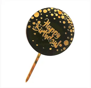Vue détaillée d'un cake topper rond en acrylique noir et doré avec le texte Joyeux Anniversaire.