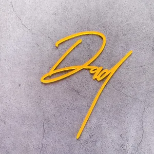 Yellow acrylic Dad cake topper for Father's Day celebration and party dessert decoration.