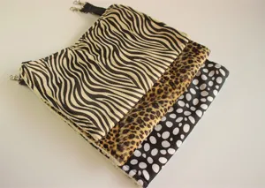 Pet hammock detail showing multiple animal print designs like zebra and leopard with hanging clips.