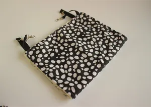 Black and white pebble pattern pet hammock detail with cozy plush lining and hanging clips.