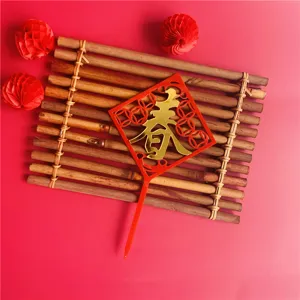 Details of the Chinese New Year acrylic cake topper featuring a festive red spring character design.