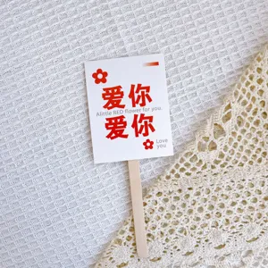 Close-up detail shot of Mother's Day cake topper card featuring love text and wooden stick.