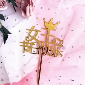 Gold acrylic crown cake topper detail with happy goddess day text on pink mesh background.