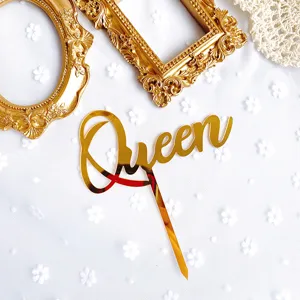 Gold acrylic Queen cake topper detail shot, shiny reflective finish for great party decor.