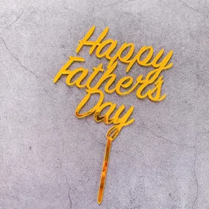 Gold acrylic Happy Father's Day cake topper detail, elegant metallic party decoration.