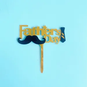 Detailed close-up view of the black and gold acrylic Father's Day cake topper with mustache and tie.
