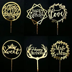 Close-up details of gold acrylic cake toppers featuring various festive text designs.