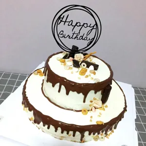 Acrylic Happy Birthday cake topper inserted on a delicious two-tier chocolate drip cake.