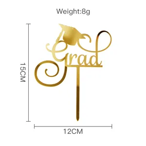 Gold acrylic graduation cake topper with grad lettering and cap design for party decor.