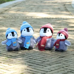 Cute penguin plush toy with knit hat and scarf, soft stuffed doll for kids birthday gift.