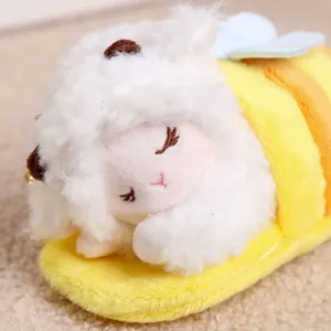 Close up view of a cute sleeping sheep plush toy pendant in bee costume, soft texture detail.