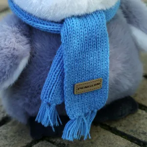 Cute penguin plush toy with blue knitted scarf, soft stuffed animal gift for kids and girls.