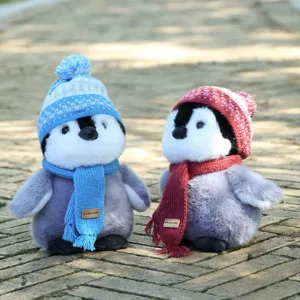 Cute penguin plush toy with knitted hat and scarf, soft stuffed animal gift for kids.