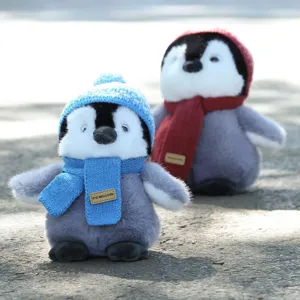 Cute plush penguin toy with knitted hat and scarf, perfect birthday gift for kids.