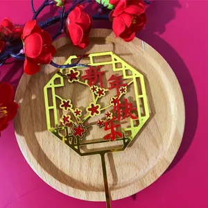 Details of the Chinese style red and gold acrylic Happy New Year plum blossom cake topper.