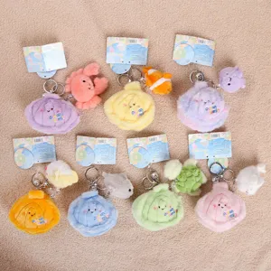 Detailed shot of cute plush shell keychains with ocean animal toys like fish and crab hanging.