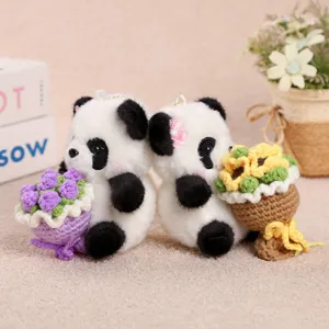 Detailed shot of cute plush panda keychains holding handmade crochet flower bouquets in cozy setting.