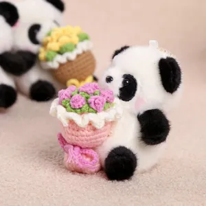 Cute plush panda keychain holding a mini crochet flower bouquet, soft toy accessory.