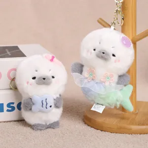 Cute plush seal keychain detail showing soft fabric, cute mermaid and fish design pendant.
