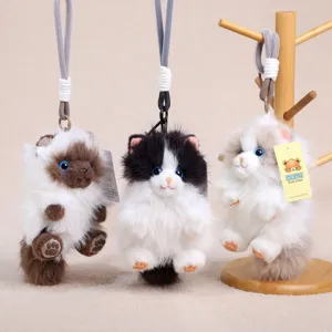 Detailed view of fluffy longhair cat plush bag pendants, cute keychains with soft faux fur.