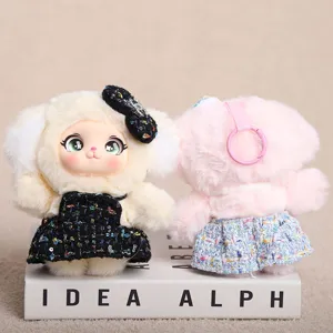 Cute plush doll keychain detail showing soft vinyl face and tweed dress, lovely toy.