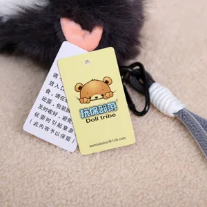 Cute plush cat keychain detail shot with brand hangtag and black clasp, soft toy pendant.