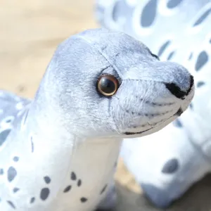Close-up view of cute spotted seal plush toy, soft stuffed animal head detail showing cute eyes.