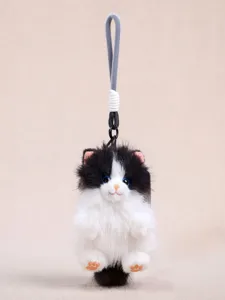 Cute black and white long-haired cat plush keychain pendant, soft fluffy toy accessory.