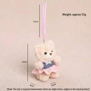 Close-up of cute plush teddy bear toy with pink lanyard and denim skirt, detailed view.