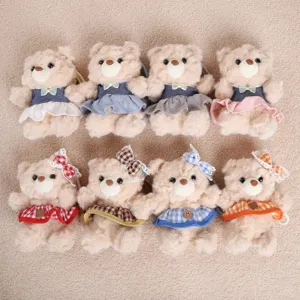 Cute plush teddy bear doll with lovely dress and bow, perfect gift for girls and claw machine toy.