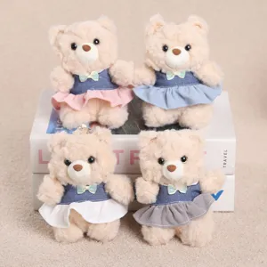 Cute plush teddy bear keychain featuring denim top and colorful skirt, perfect gift.