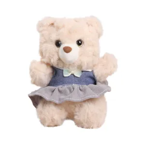Cute plush teddy bear toy wearing a stylish denim dress and shiny bow, soft stuffed doll gift.